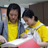 Two participants trying to “read” braille book