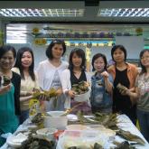 Parents joining an activity of making rice dumpling