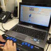 A visually impaired person using power brialle to do online shopping