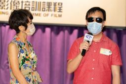 Ms Jacqueline Pang chit-charted with visually impaired person Mr Joseph Yam
