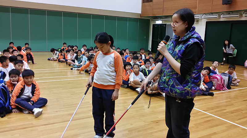 Visually impaired public education ambassador sharing with students at school