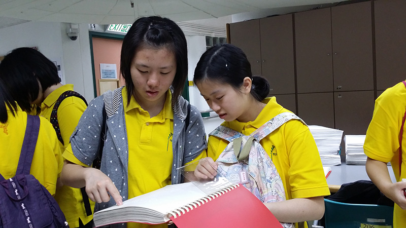 Two participants trying to “read” braille book
